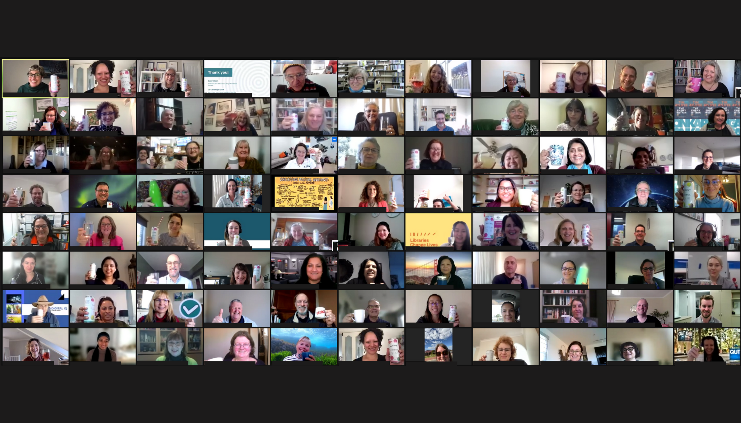 Screenshot of zoom video call with many people smiling.